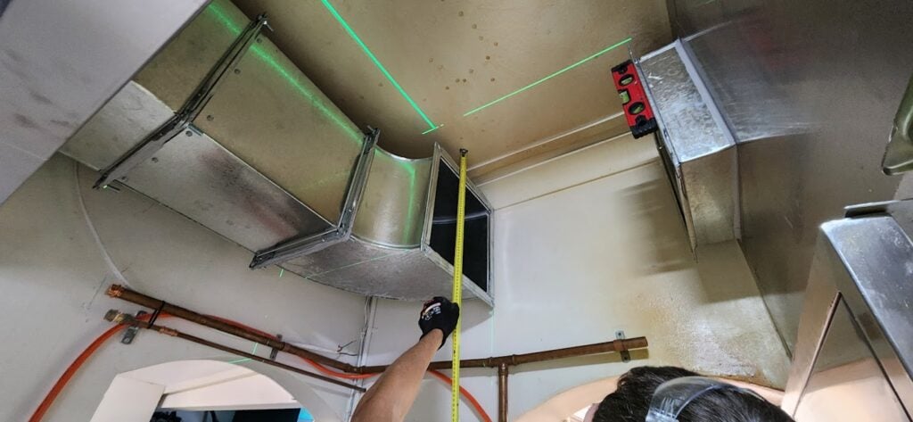 ben at work measuring kitchen fan